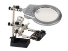 Troisième main avec loupe et lampe